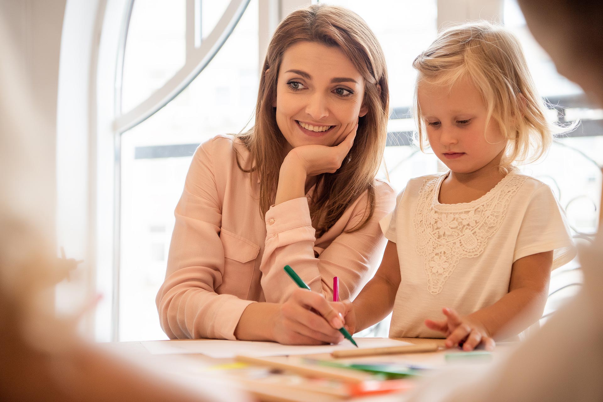 smiling educator and adorable kid drawing together 2022 11 02 02 16 00 utc