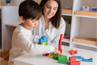 kid playing with wood blocks and teacher educador 2021 09 02 10 31 18 utc.jpg