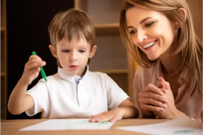 smiling educator looking at boy drawing in kinderg 2022 11 02 02 22 09 utc.jpg