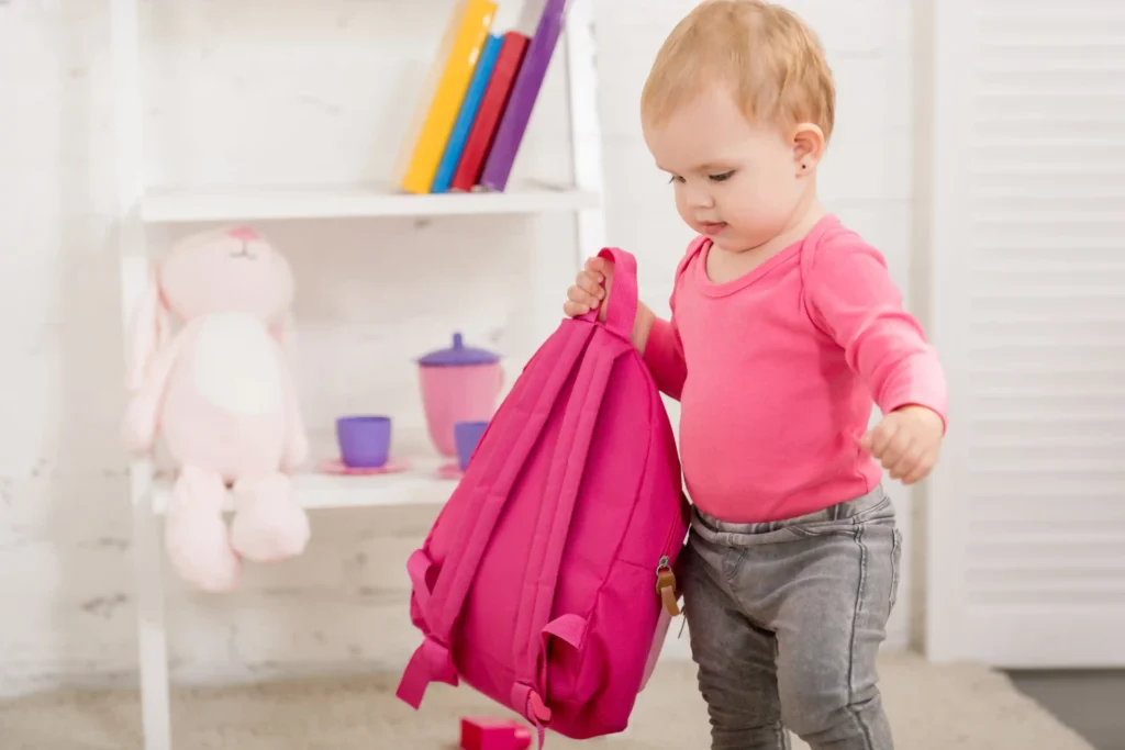How to Prepare Your Child for the First Day of Daycare/Montessori 3 toddler caring a bag at first day of daycare