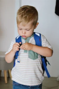 boy caring a bag at first day of daycare