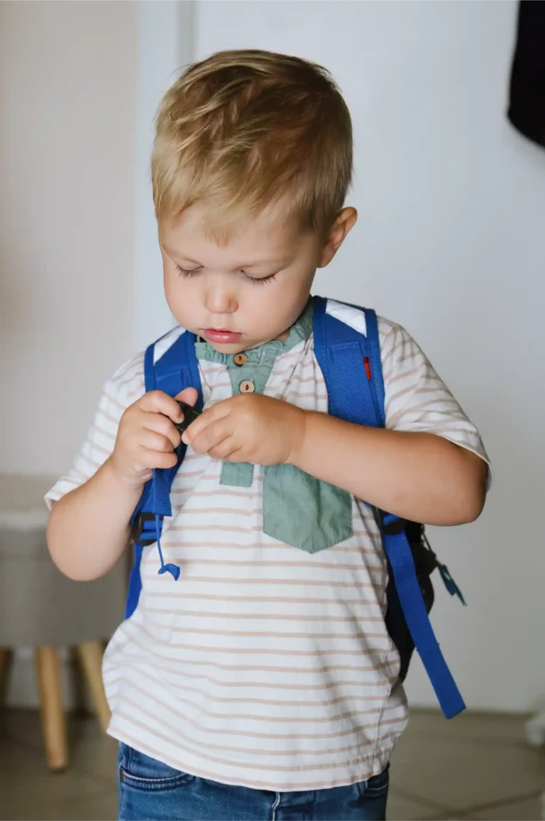 boy caring a bag at first day of daycare